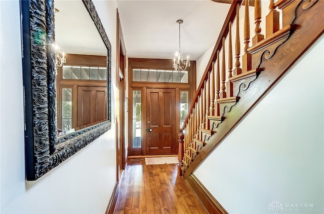 entryway featuring hardwood / wood-style floors and a chandelier