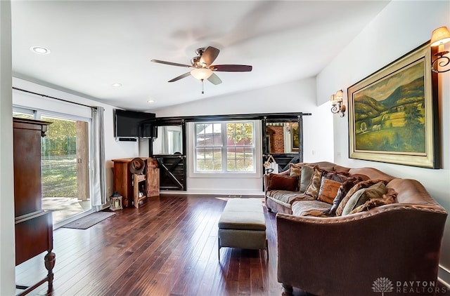 living room featuring vaulted ceiling, dark hardwood / wood-style flooring, ceiling fan, and a wealth of natural light