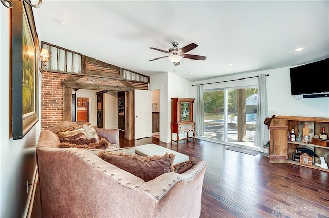 living room with lofted ceiling, ceiling fan, and dark wood-type flooring