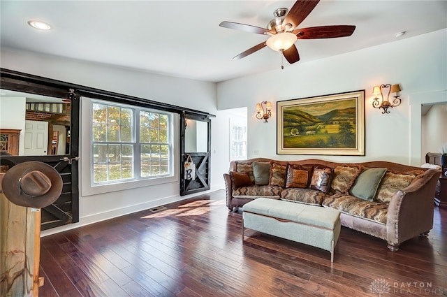 living room featuring ceiling fan, dark hardwood / wood-style floors, and vaulted ceiling