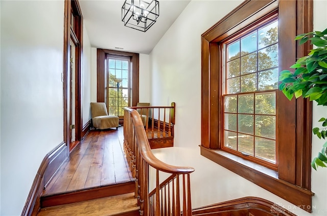 interior space featuring wood-type flooring, an inviting chandelier, and vaulted ceiling