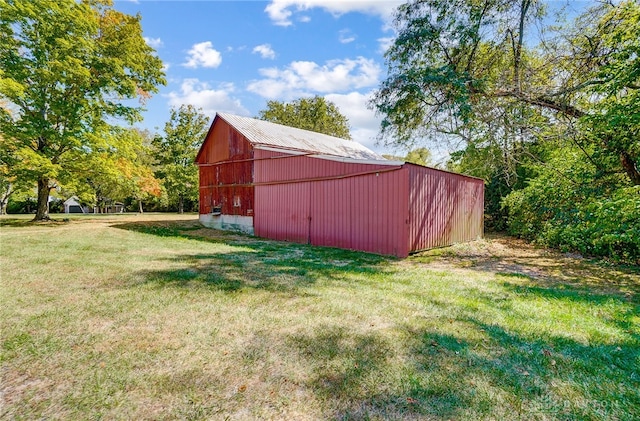 view of outbuilding featuring a yard