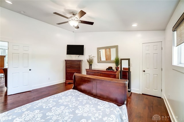 bedroom with lofted ceiling, dark hardwood / wood-style floors, and ceiling fan