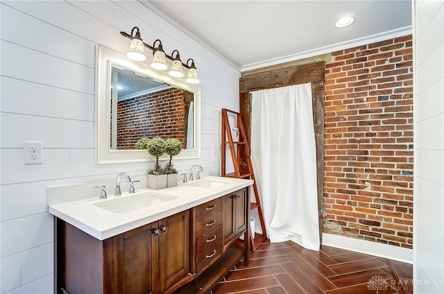 bathroom featuring ornamental molding, vanity, wood walls, and parquet flooring