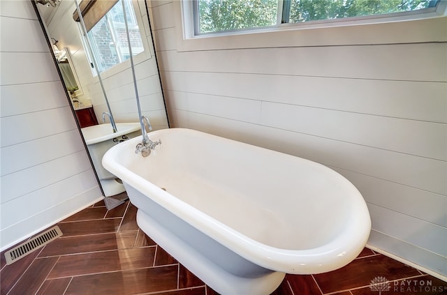 bathroom with a bathing tub and tile patterned floors