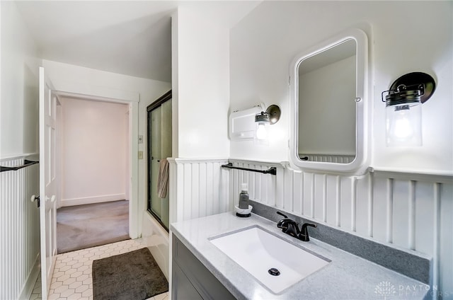 bathroom featuring vanity and bath / shower combo with glass door