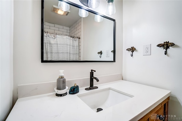 bathroom with walk in shower and vanity