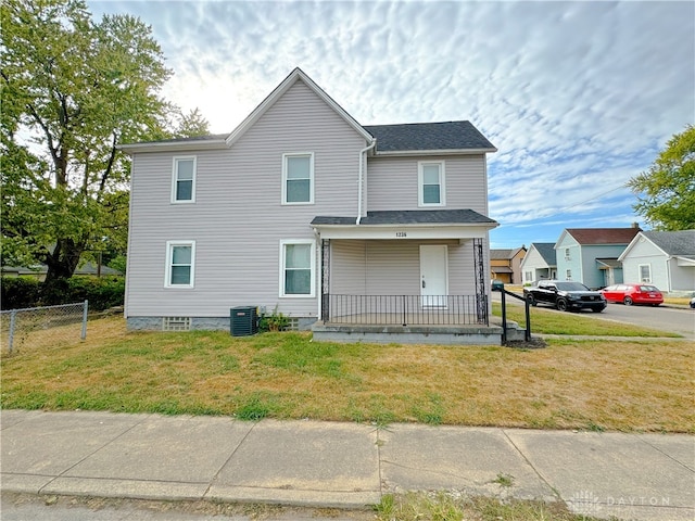 view of front facade featuring a front lawn, central AC unit, and a porch