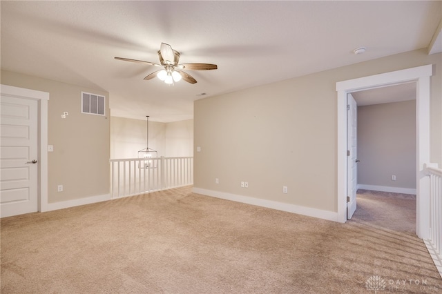 carpeted spare room featuring ceiling fan