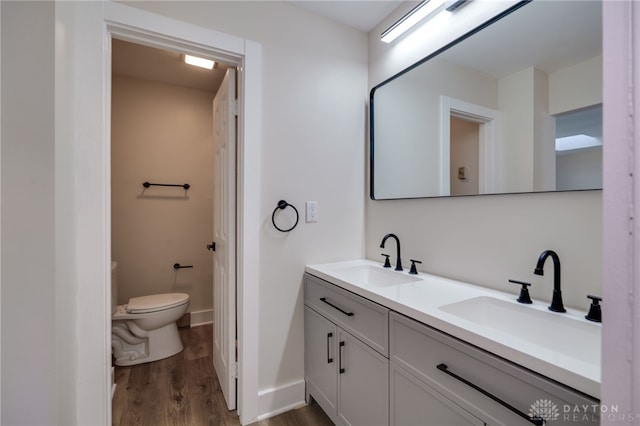 bathroom featuring hardwood / wood-style floors, vanity, and toilet