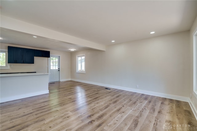 unfurnished living room with light wood-type flooring