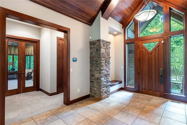 tiled foyer entrance featuring french doors, vaulted ceiling, and wood ceiling