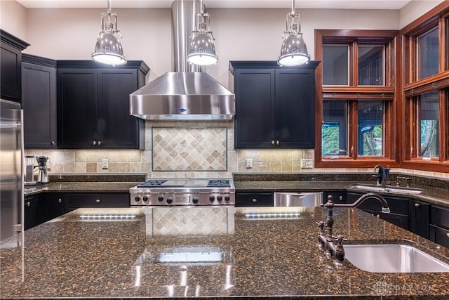 kitchen with sink, wall chimney exhaust hood, and pendant lighting