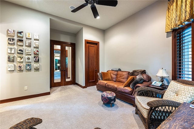 carpeted living room with french doors and ceiling fan