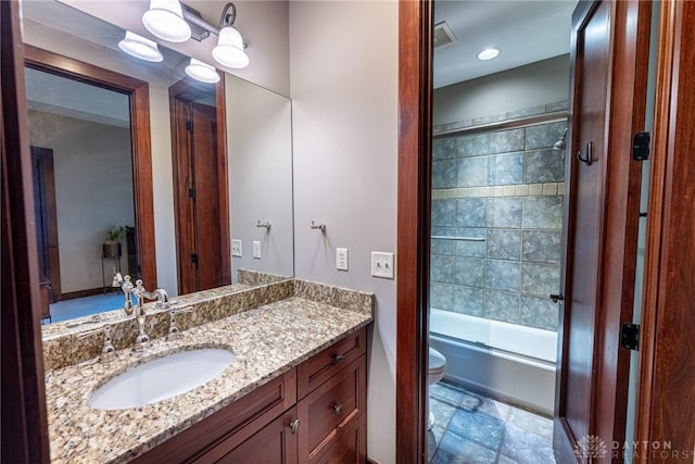 full bathroom featuring shower / bath combination with glass door, vanity, and toilet