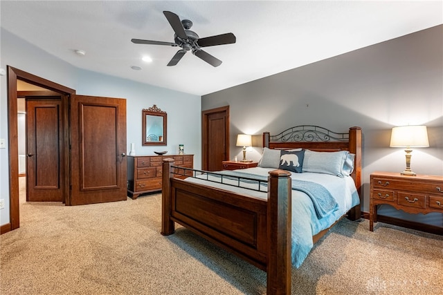 bedroom with ceiling fan and light carpet