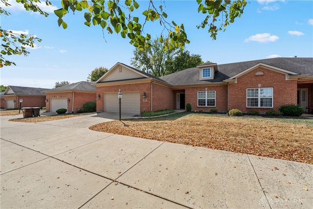 ranch-style home featuring a garage and a front lawn