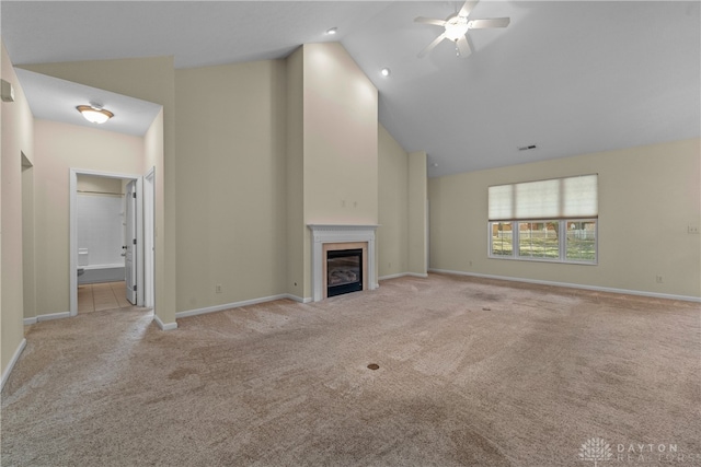 unfurnished living room with high vaulted ceiling, light carpet, and ceiling fan