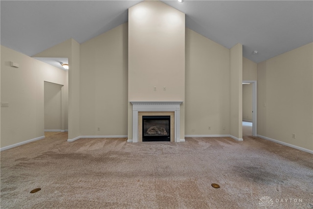 unfurnished living room with light colored carpet and lofted ceiling