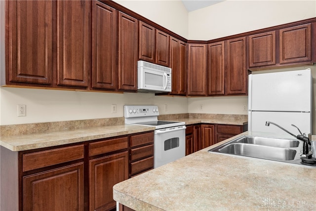 kitchen featuring white appliances and sink