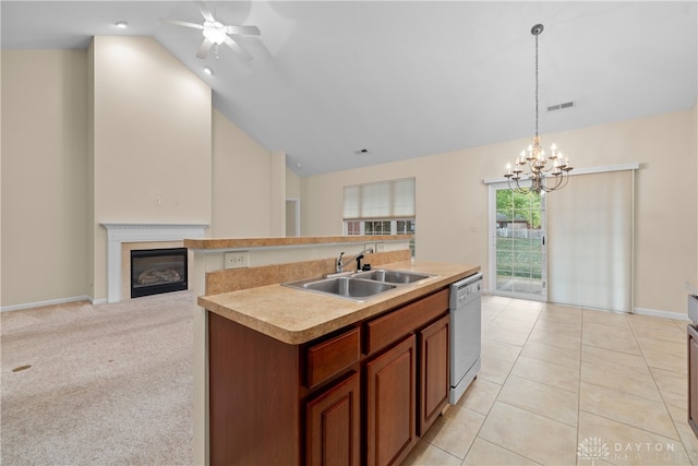 kitchen featuring sink, decorative light fixtures, an island with sink, light colored carpet, and dishwasher