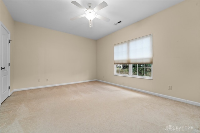 carpeted spare room featuring ceiling fan