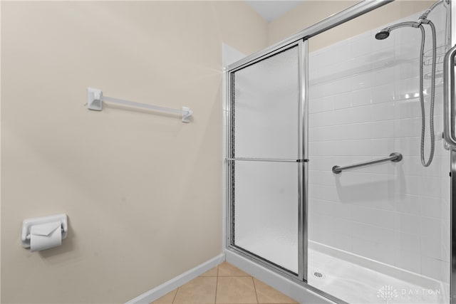 bathroom featuring tile patterned flooring and a shower with door