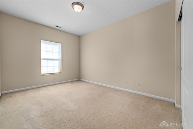 empty room featuring light colored carpet