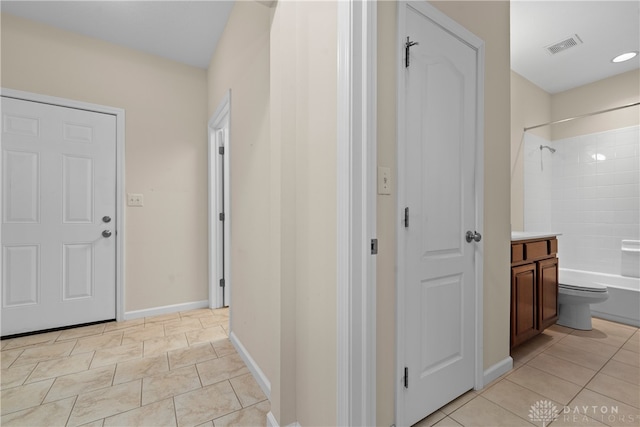 corridor featuring light tile patterned flooring