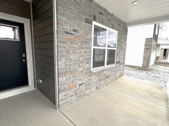 view of exterior entry featuring covered porch