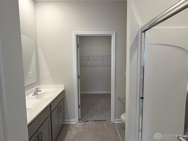 bathroom featuring vanity, toilet, and concrete floors