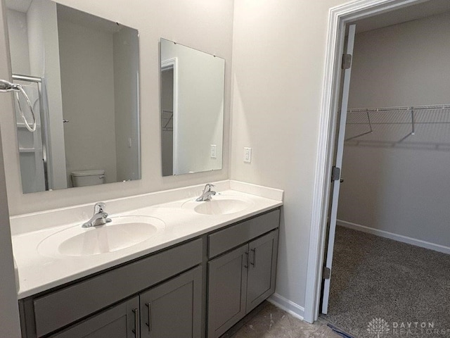 bathroom featuring vanity and toilet