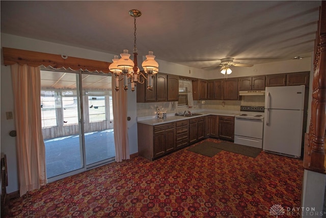 kitchen featuring pendant lighting, tasteful backsplash, sink, ceiling fan with notable chandelier, and white appliances