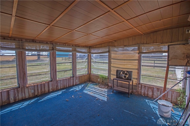 unfurnished sunroom with wood ceiling and a healthy amount of sunlight