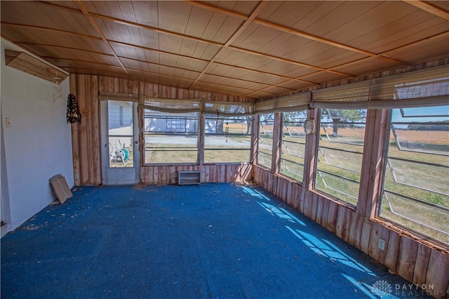 unfurnished sunroom featuring wood ceiling and lofted ceiling