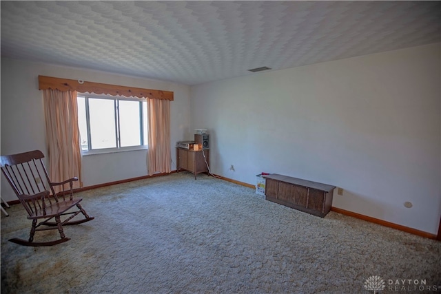 unfurnished room with a textured ceiling and carpet