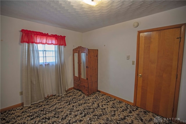 spare room with carpet and a textured ceiling