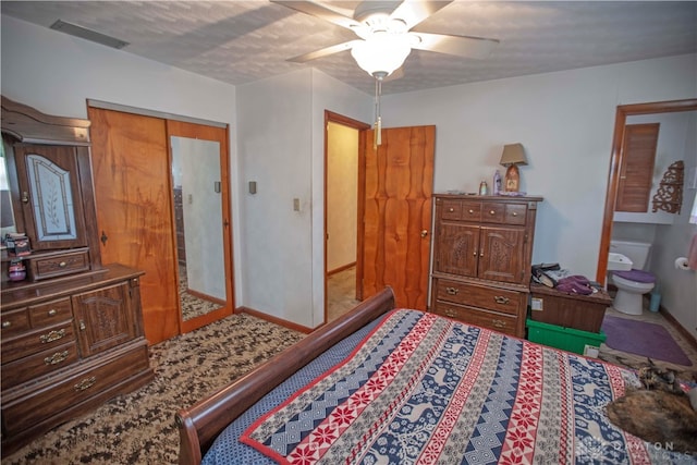 bedroom with ceiling fan, ensuite bathroom, and a closet