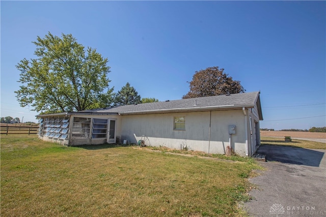 rear view of house with a lawn