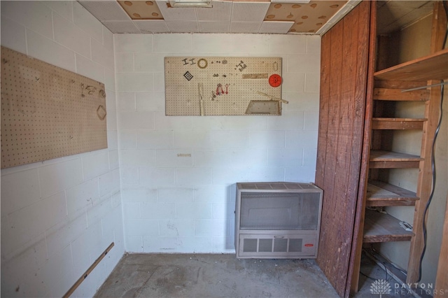 interior space featuring heating unit and concrete flooring