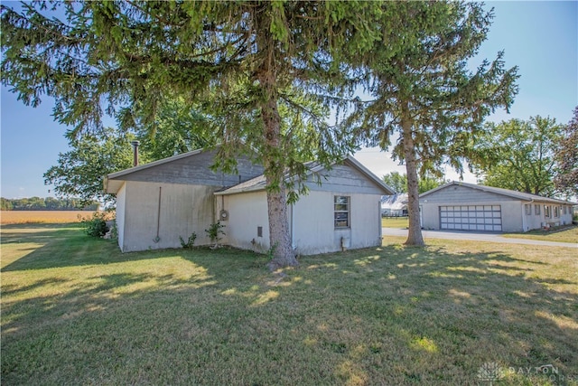 exterior space with a lawn, an outbuilding, and a garage