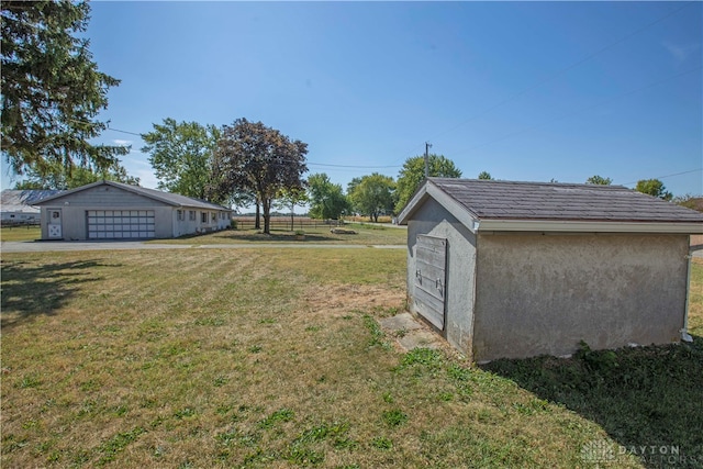 view of yard with an outbuilding and a garage