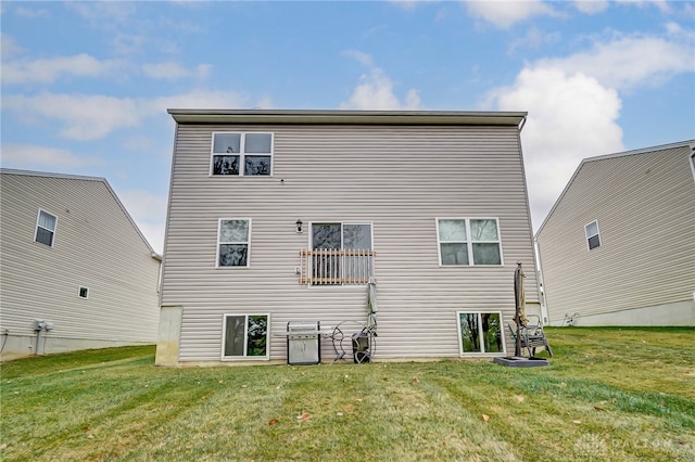 rear view of house featuring a yard