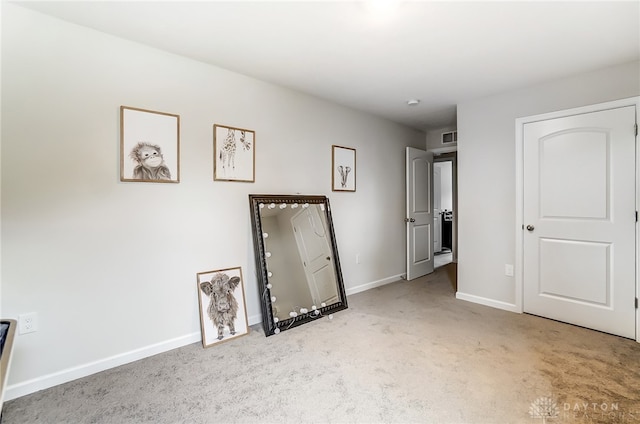 unfurnished bedroom featuring light carpet