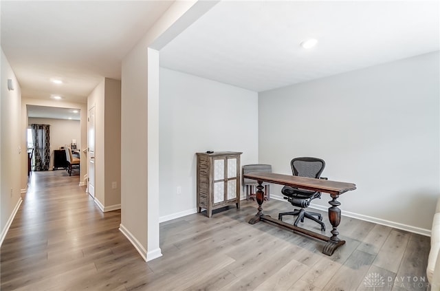 office area with light hardwood / wood-style floors