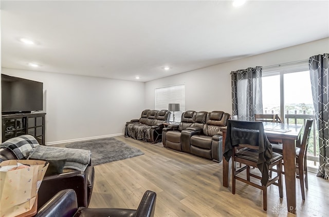 living room with plenty of natural light and light hardwood / wood-style flooring