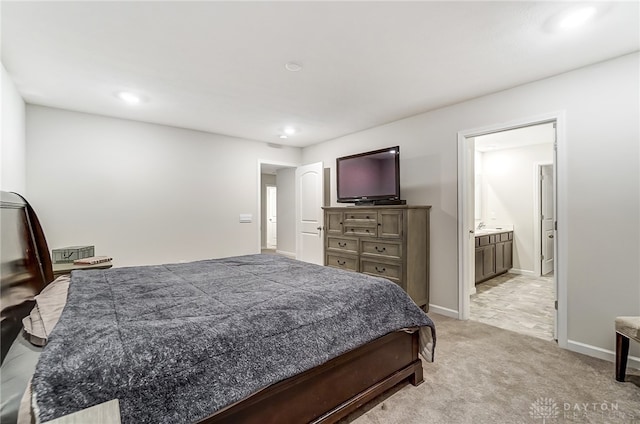 carpeted bedroom with ensuite bath