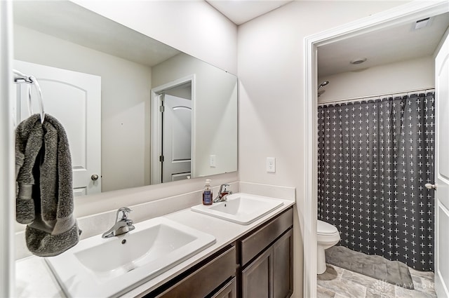 bathroom featuring curtained shower, vanity, and toilet