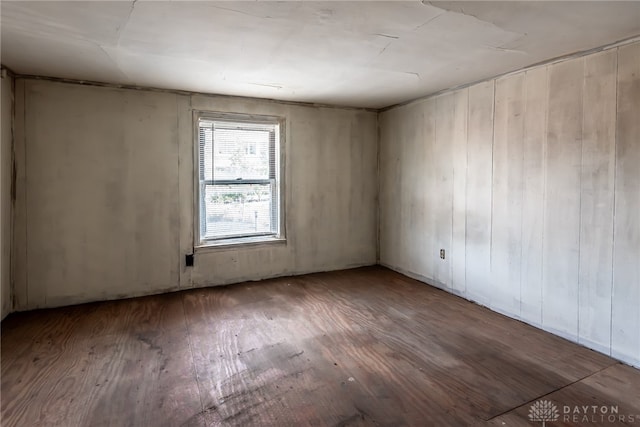 spare room with wood-type flooring