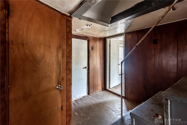 foyer entrance featuring wooden walls